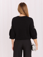 Black short sweater with rhinestones.