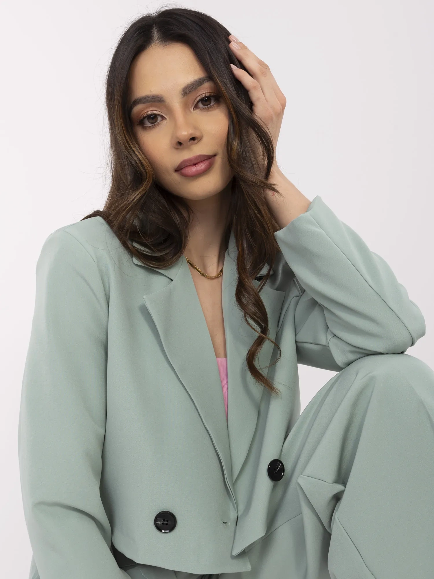 Pistachio suit with pleats on the pants.
