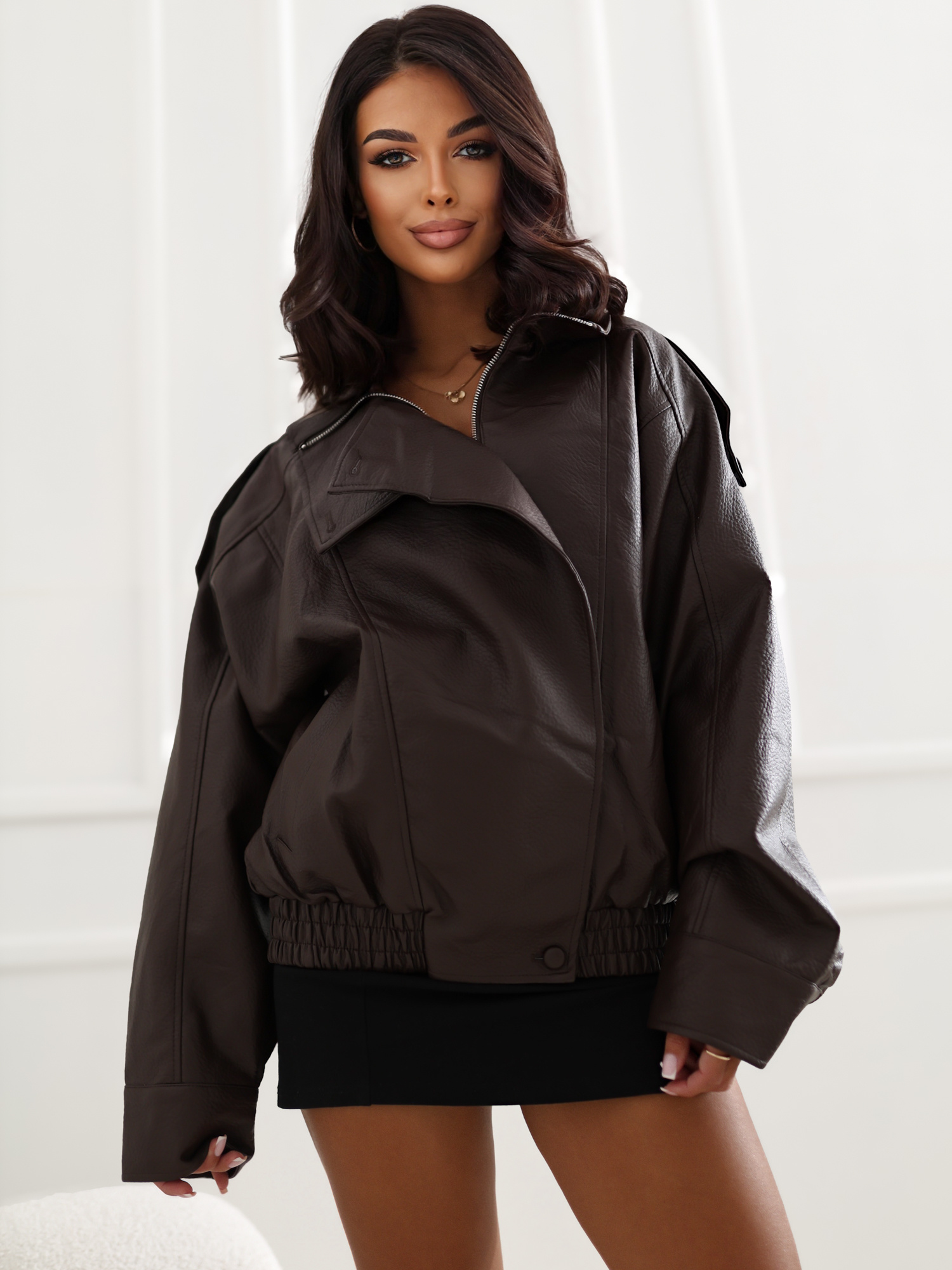 Brown oversized faux leather jacket with epaulettes.