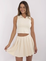 Light beige sports set with a pleated skirt.