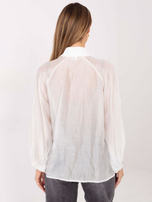 White transparent shirt with decorative buttons.