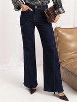Modré dámské džíny s vertikálními švy.