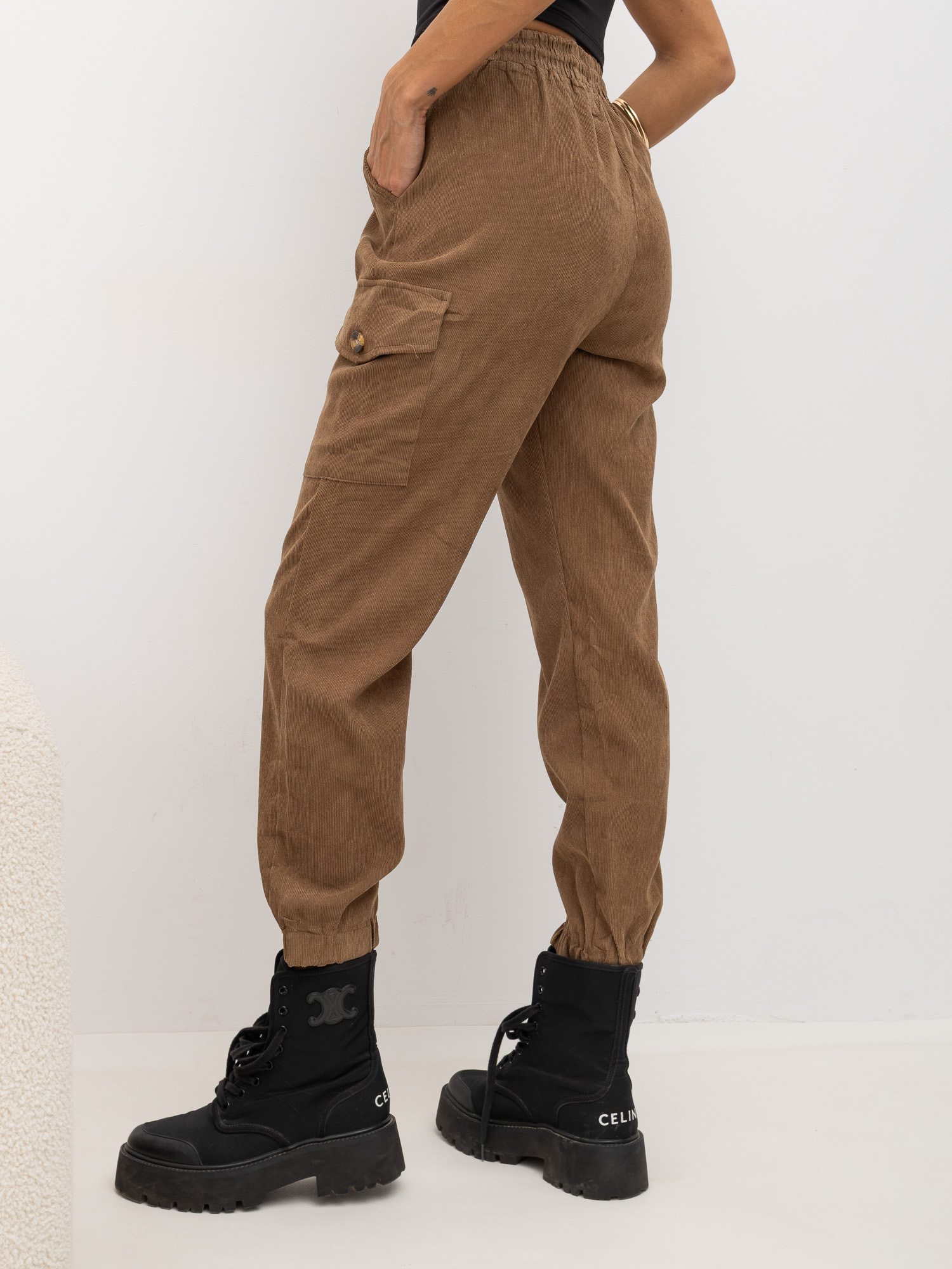 Brown corduroy pants with cuffs at the bottom.