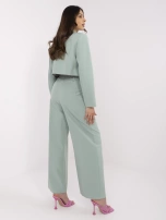 Pistachio suit with pleats on the pants.