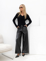 Black ribbed sweater with decorative buttons.