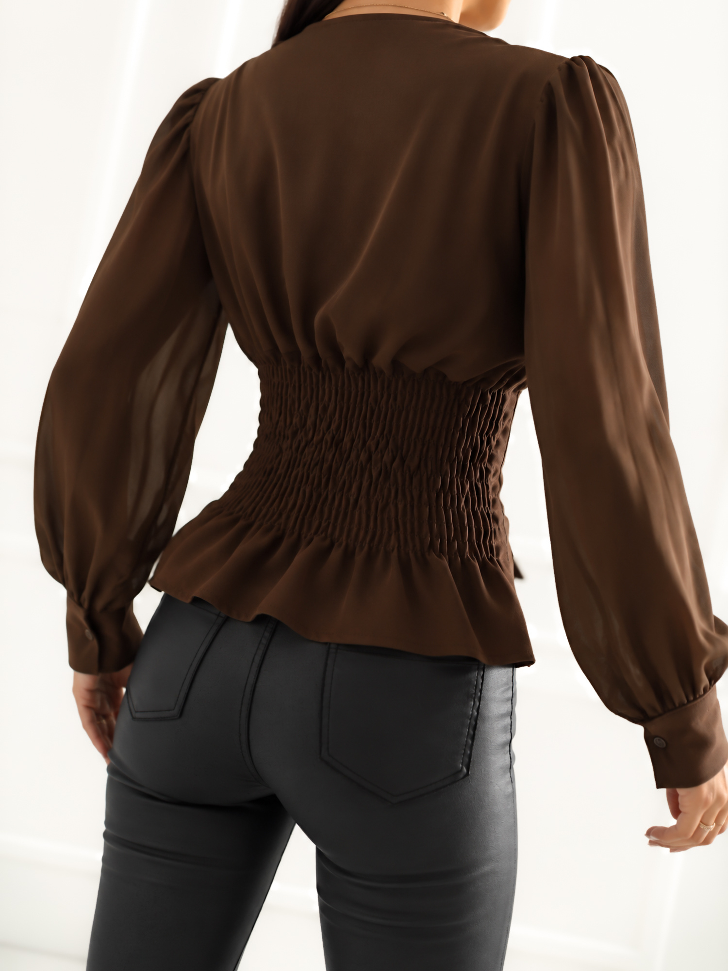 Brown corset blouse with puff sleeves.
