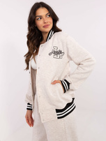 Hurt Jasnobeżowa melanżowa bluza bomberka z naszywką