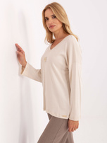 Jasnobeżowa bluzka oversize z długim rękawem