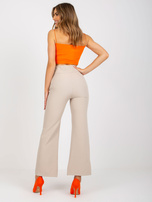 Beżowe eleganckie spodnie z materiału z kieszeniami