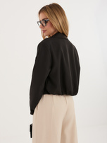 Black single-breasted blazer with a brooch.