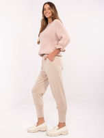 Hurt Beżowe dresowe spodnie z brązowym paskiem