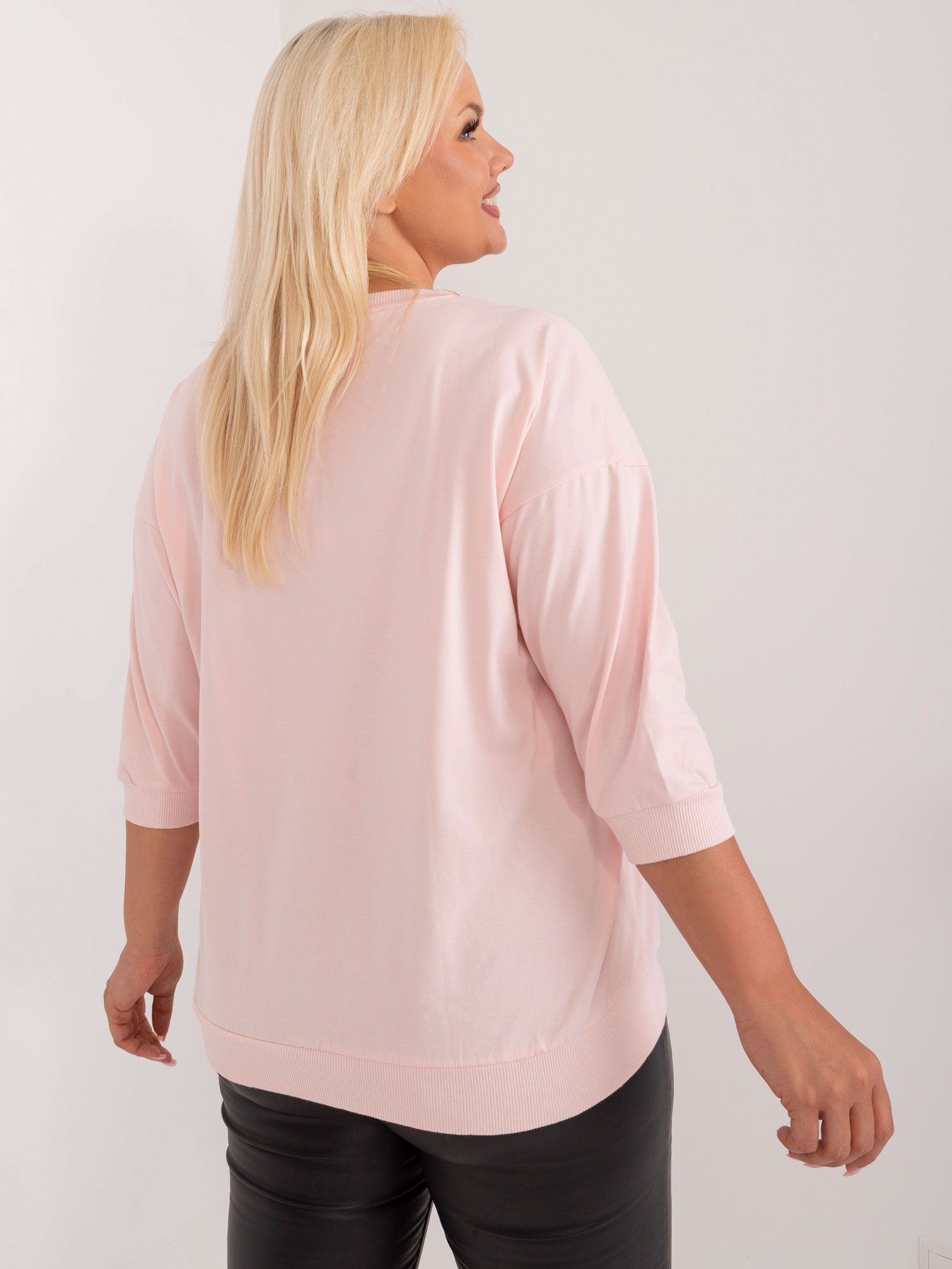 Light pink plus size blouse with an application and inscription.