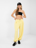 Jasnożółte dresowe spodnie z ozdobnym guzikiem