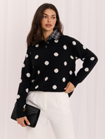Black women's oversized polka dot sweater.