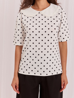White elegant polka dot blouse.