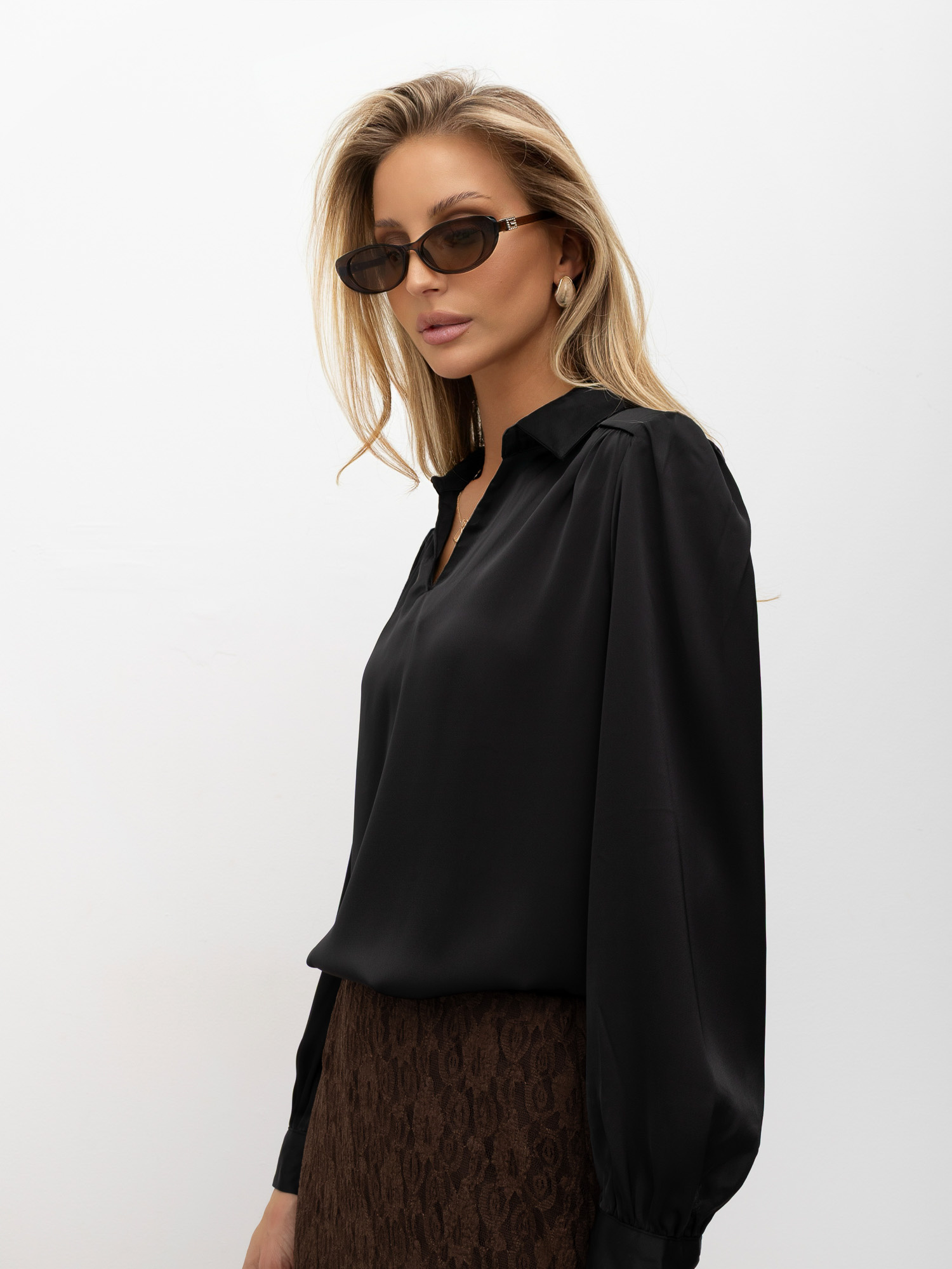 Black smooth blouse with cuffs and V-neck.