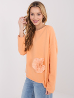 Světlě oranžová oversized mikina bez kapuce.