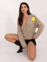 Beige zip-up sweater with a print on the back.