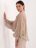Beige transparent shirt with decorative buttons.