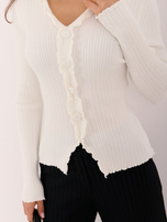 Ecru ribbed sweater with decorative buttons.