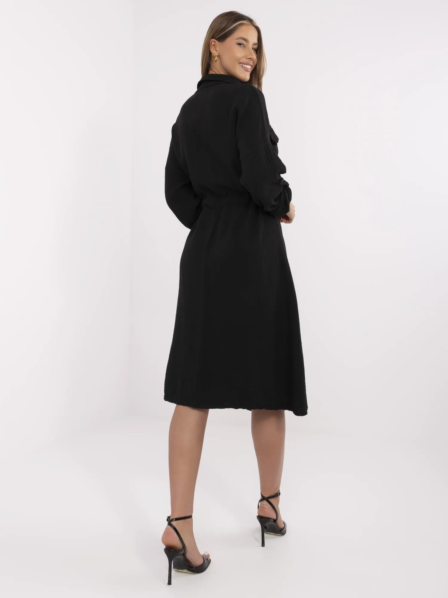 Black muslin dress with a drawstring at the waist.
