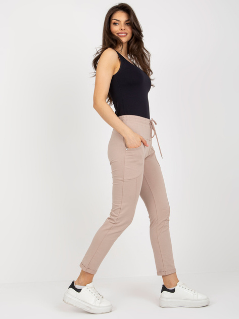 Hurt Beżowe damskie spodnie dresowe z kieszeniami