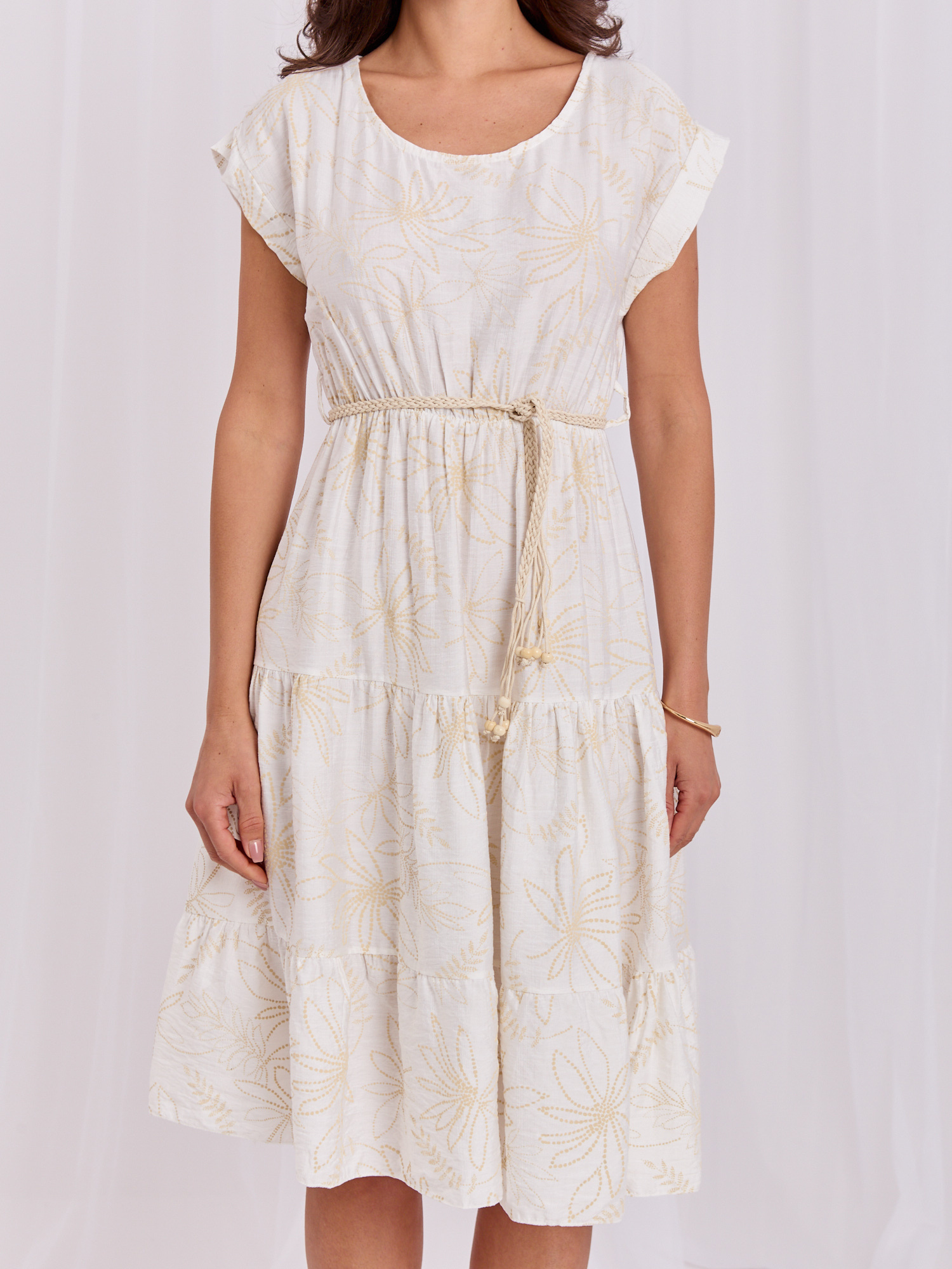 Light beige flared dress with ruffle.