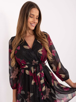 Black mini dress with a ruffle.