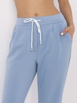 Blue trousers made of pleasant-to-touch material.