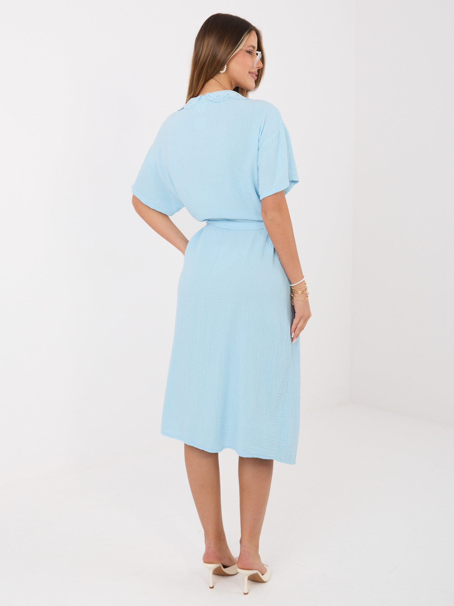 Light blue muslin dress with a tied belt.
