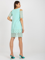 Hurt Mint cocktail dress with off-the-shoulder sleeves.