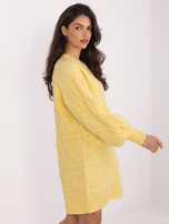 Light yellow sweater dress with braids.