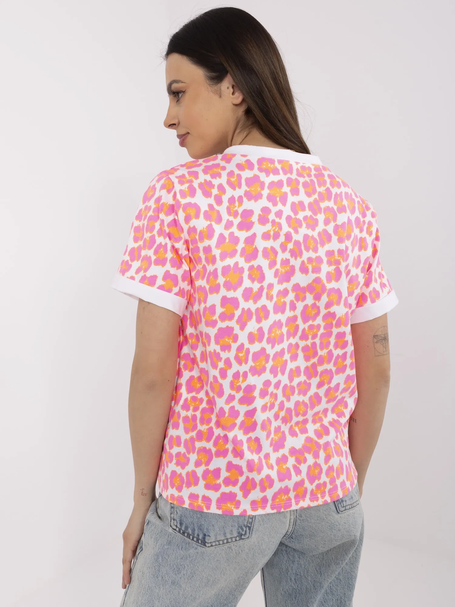 Fluorescent pink and white blouse with a round neckline.