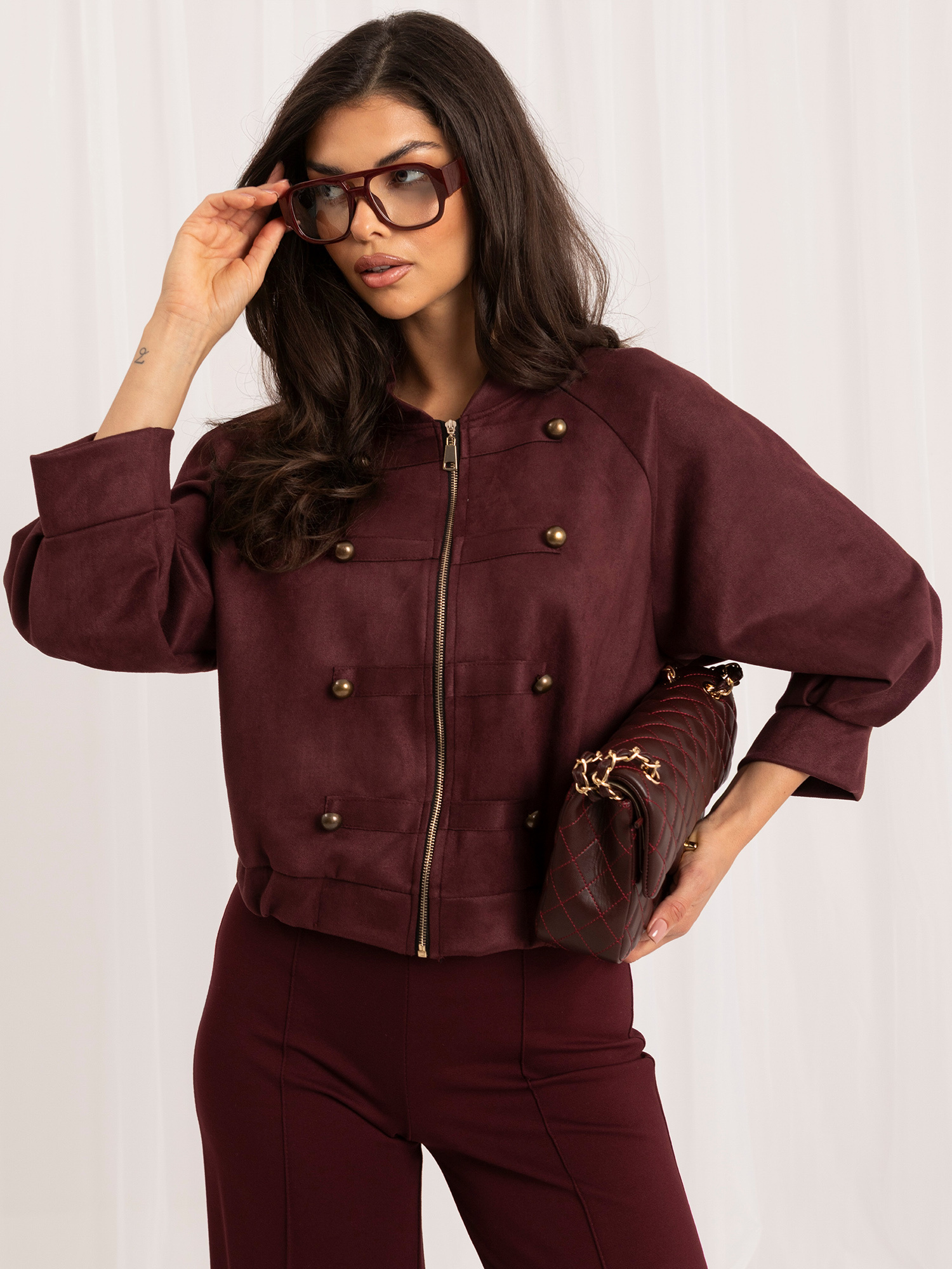 Burgundy jacket with decorative double-breasted fastening.