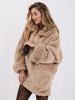 Beige women's fur coat with impressive sleeves.