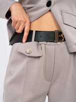 Sweatpants with decorative buttons.