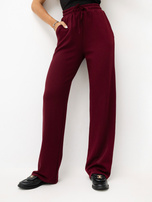Burgundy sweatpants with wide legs.