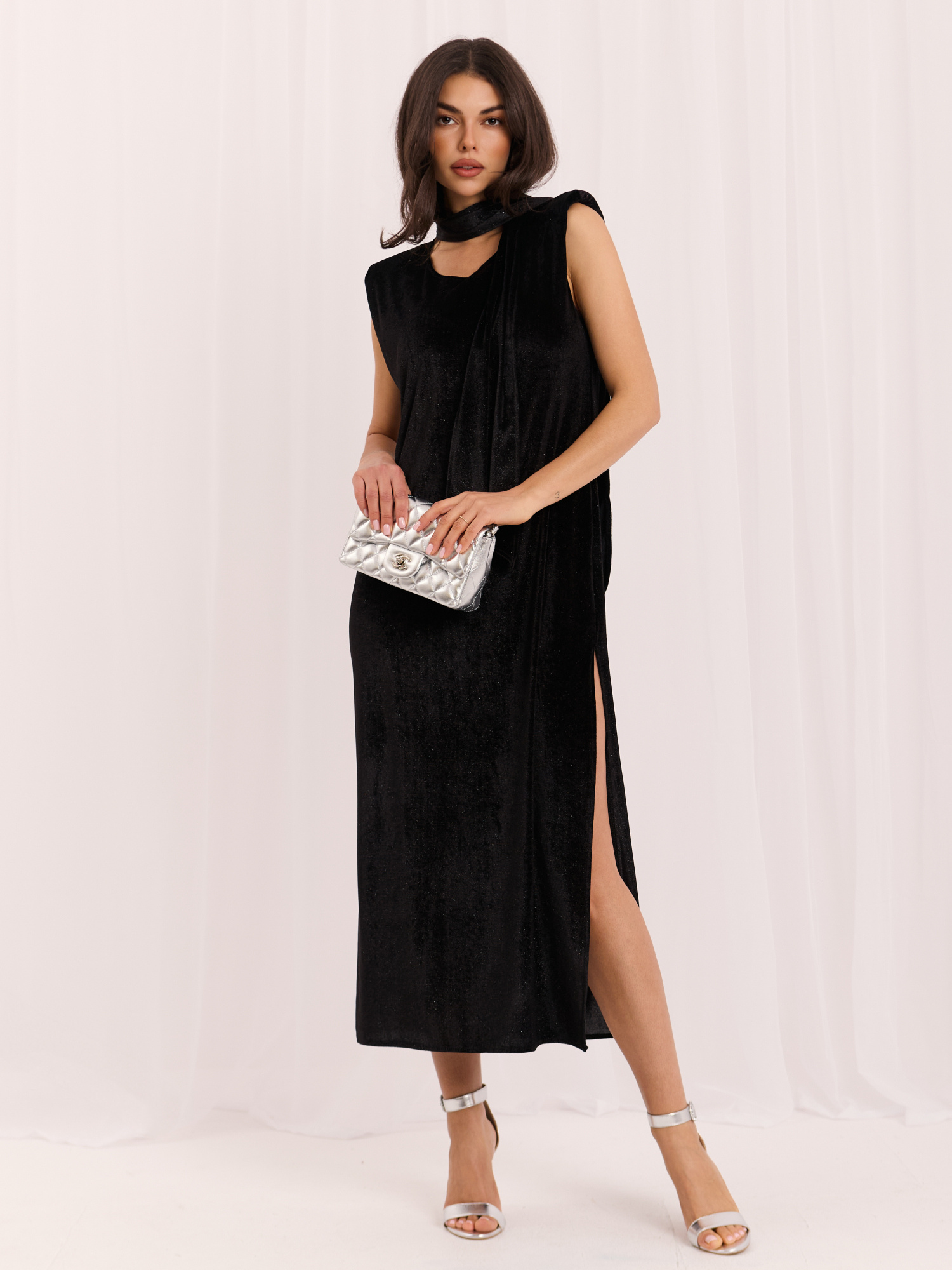 Black velvet dress with shoulder pads.