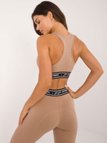 Hurt Ciemnobeżowy sportowy crop top z nadrukiem FOR FITNESS