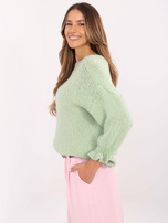 Hurtownia Pistacjowy sweter falbankami przy rękawach
