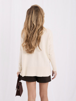 Light beige women's sweater with side braids.