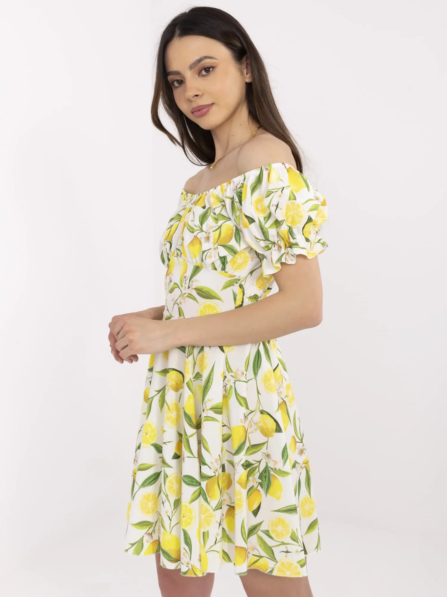 Ecru-yellow off-the-shoulder dress with lemons.