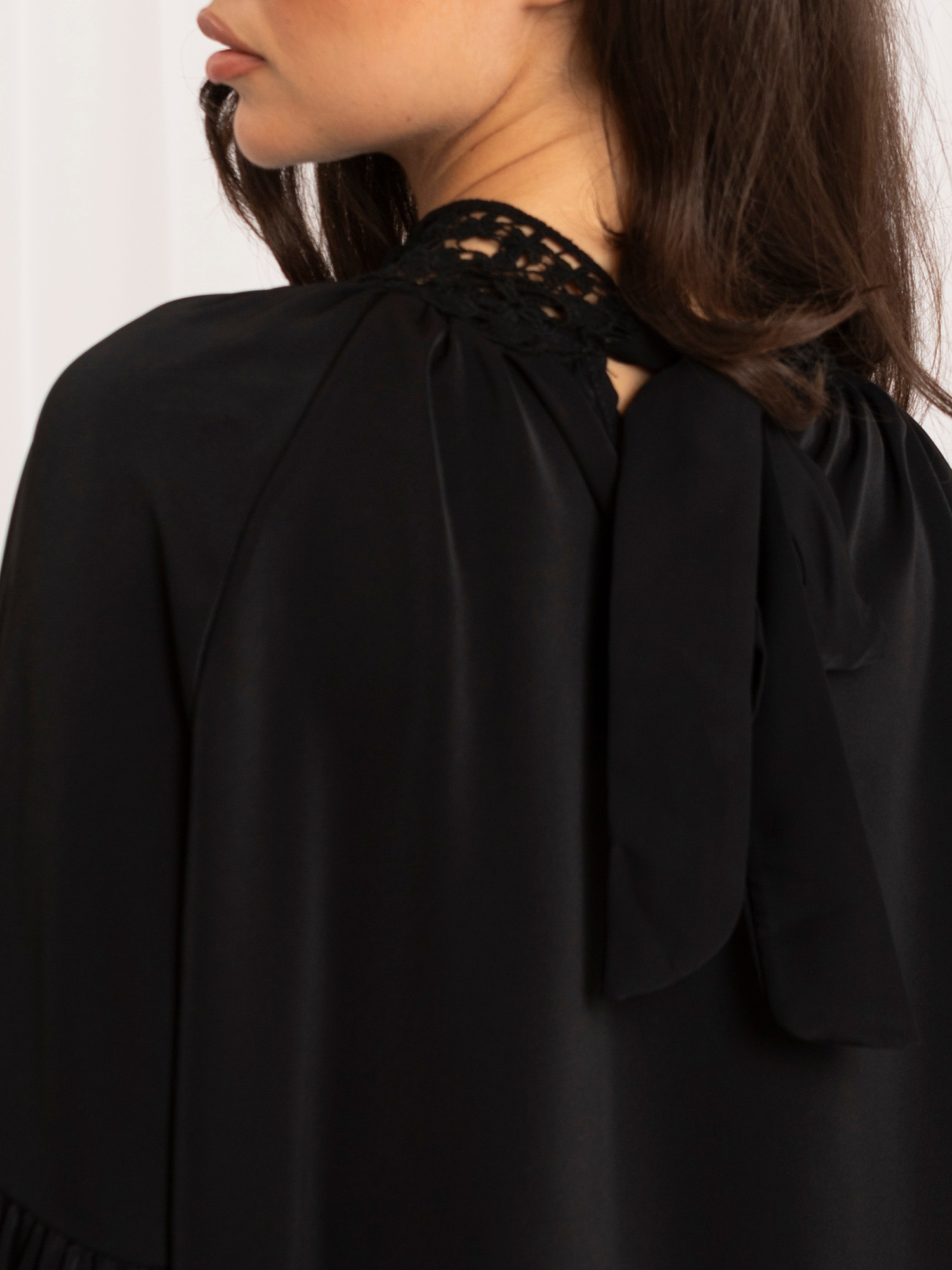 Black elegant blouse with puffed sleeves.