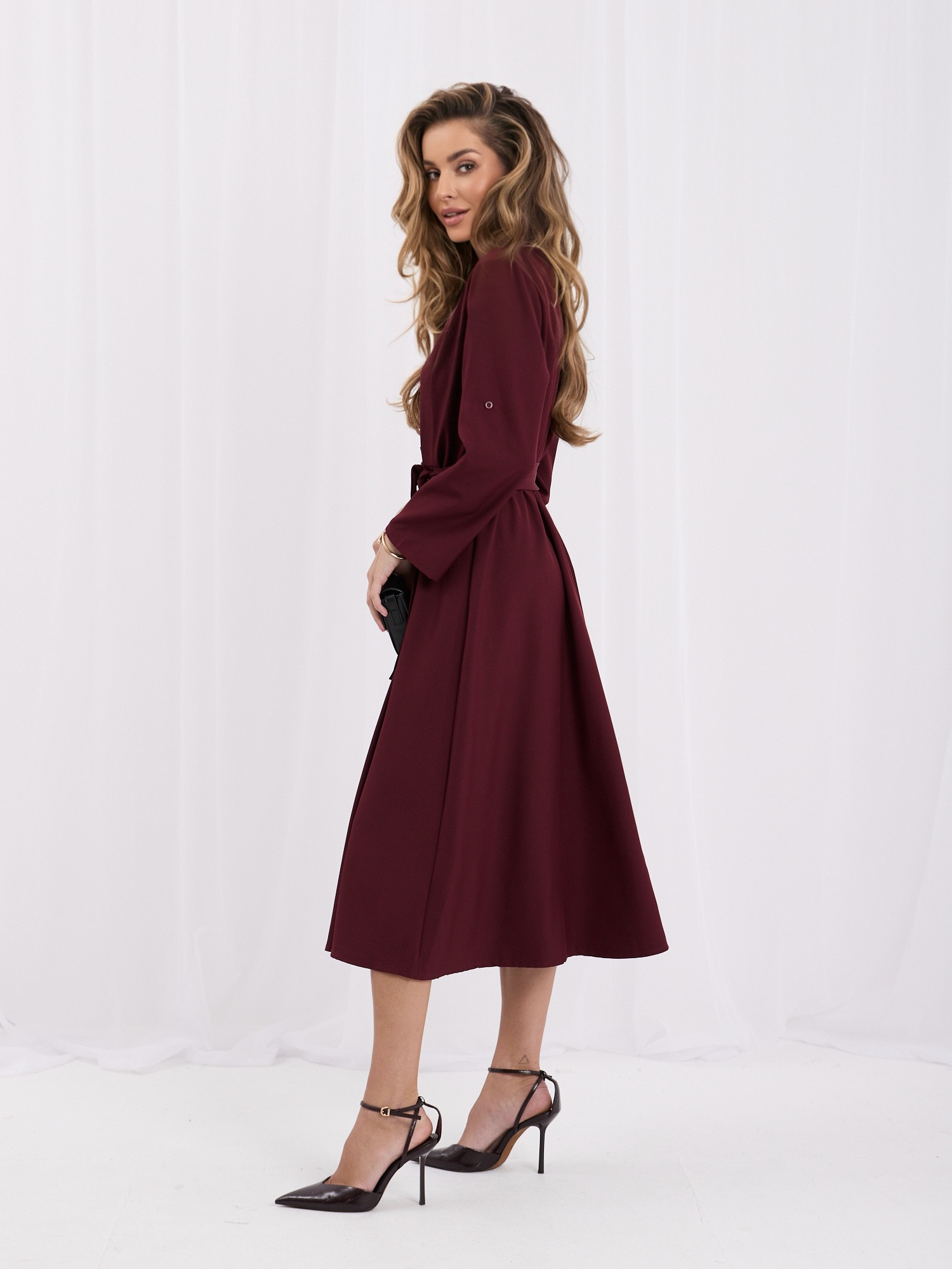 Burgundy elegant dress with decorative buttons.