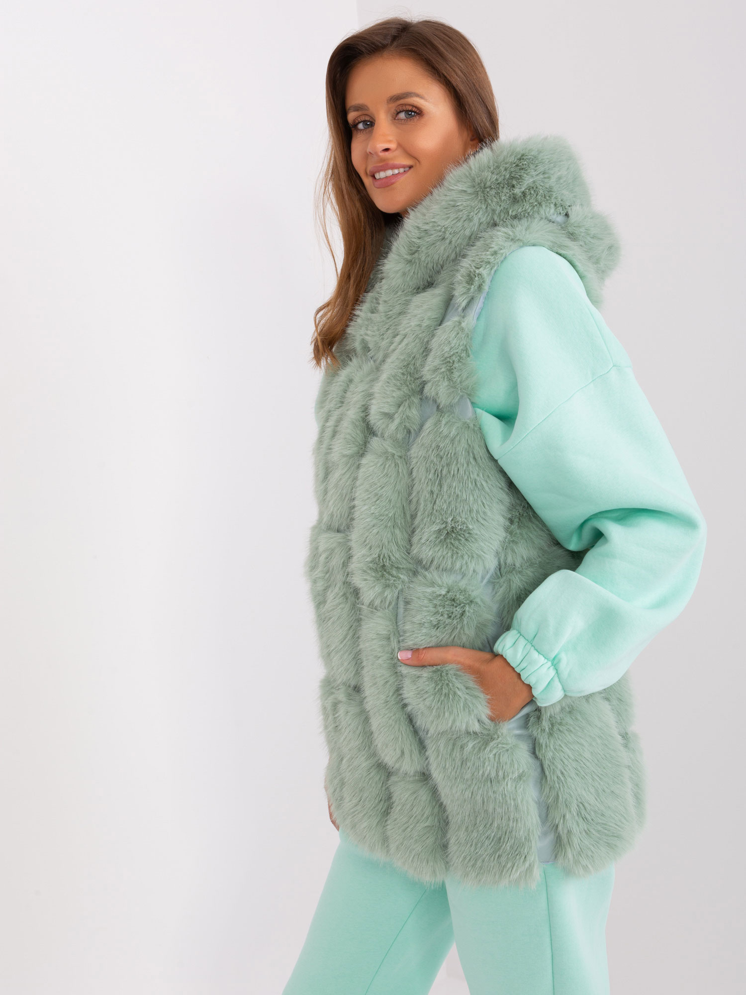 Wholesale pistachio fur vest with zip and hood.
