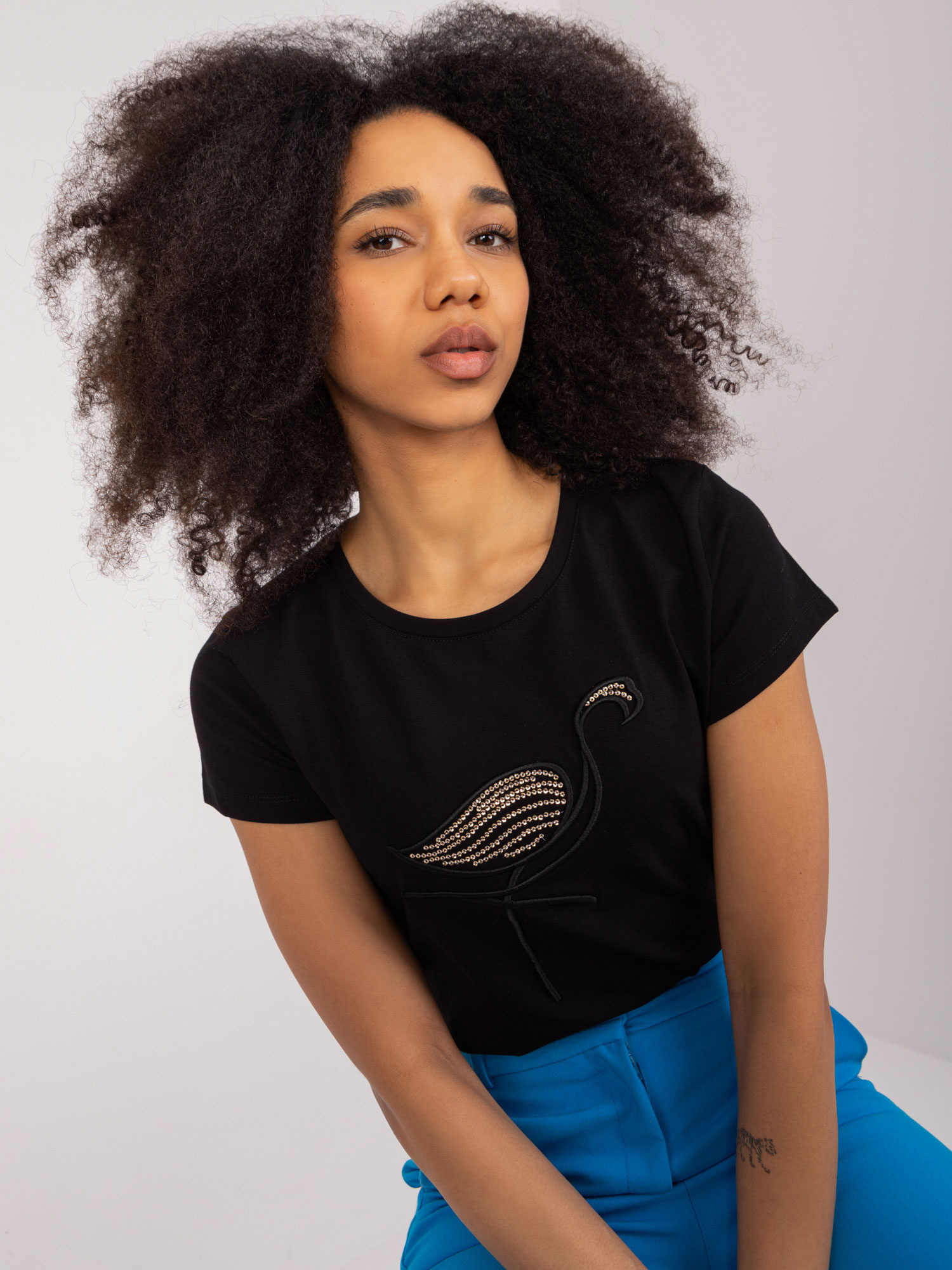 Wholesale Black T-shirt with BASIC FEEL GOOD appliqué.