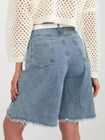 Hurt Blue long denim shorts with holes.