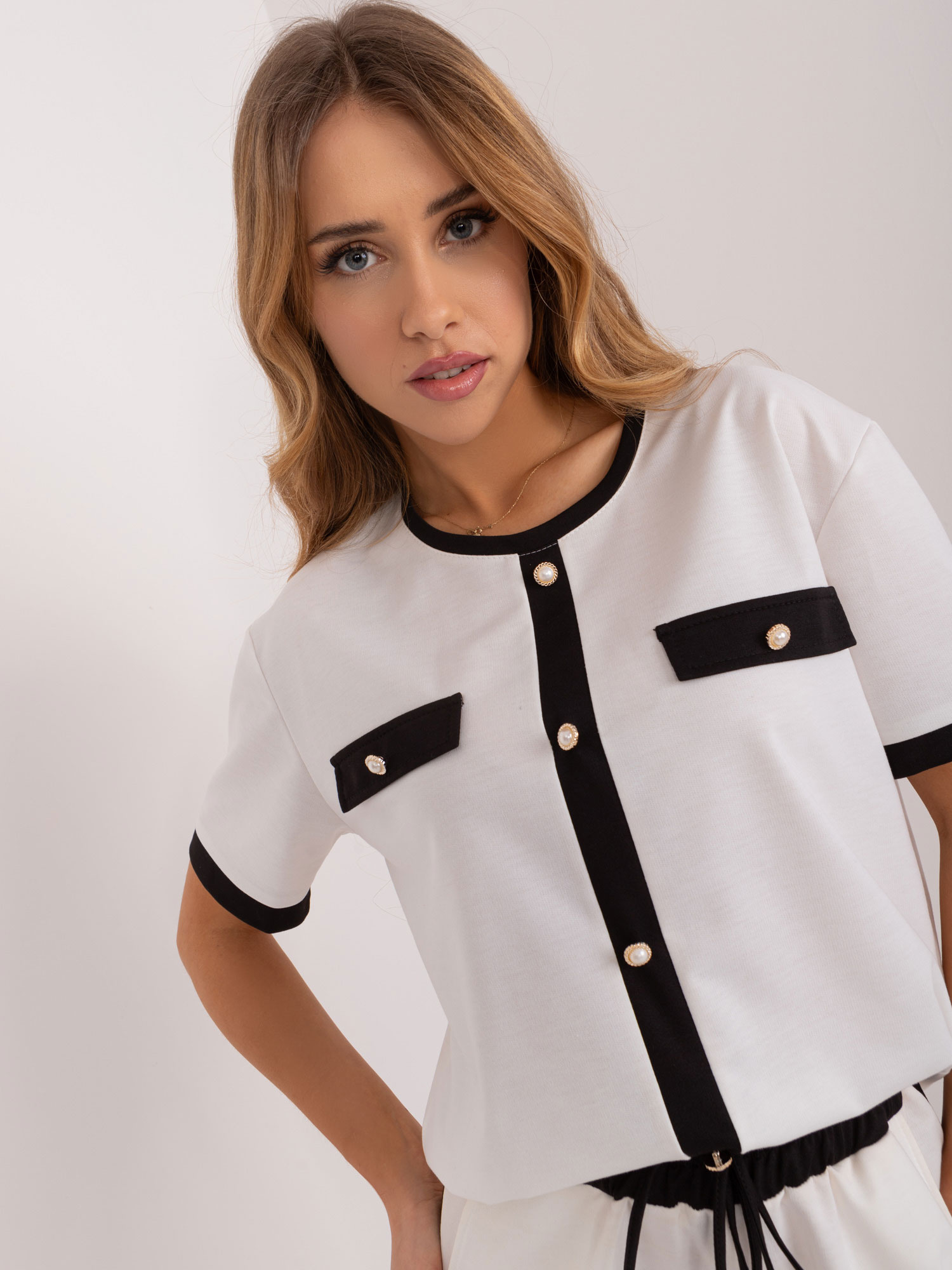 Wholesale Ecru women's blouse with decorative buttons.
