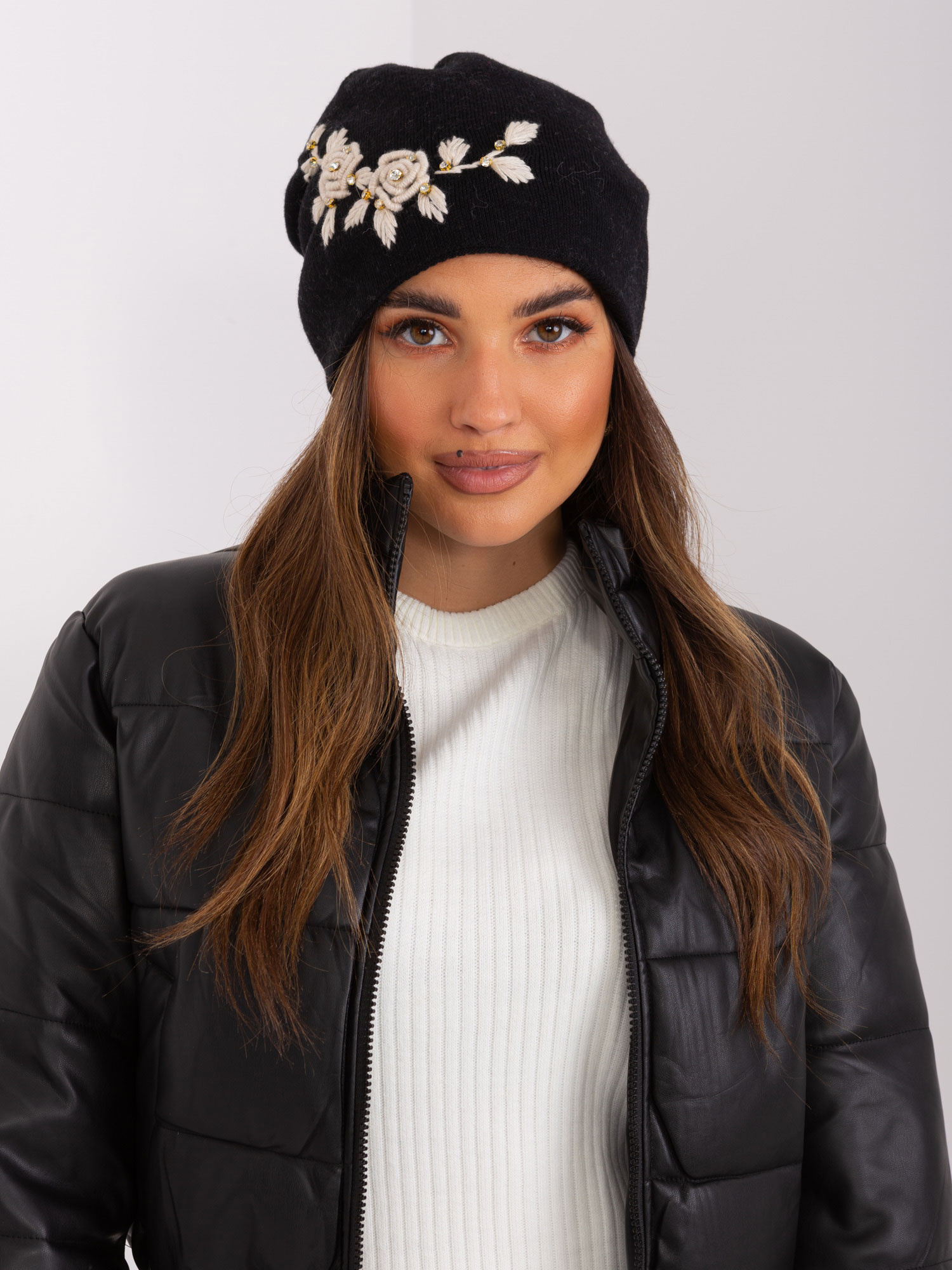Black and beige knitted hat with appliqué and rhinestones