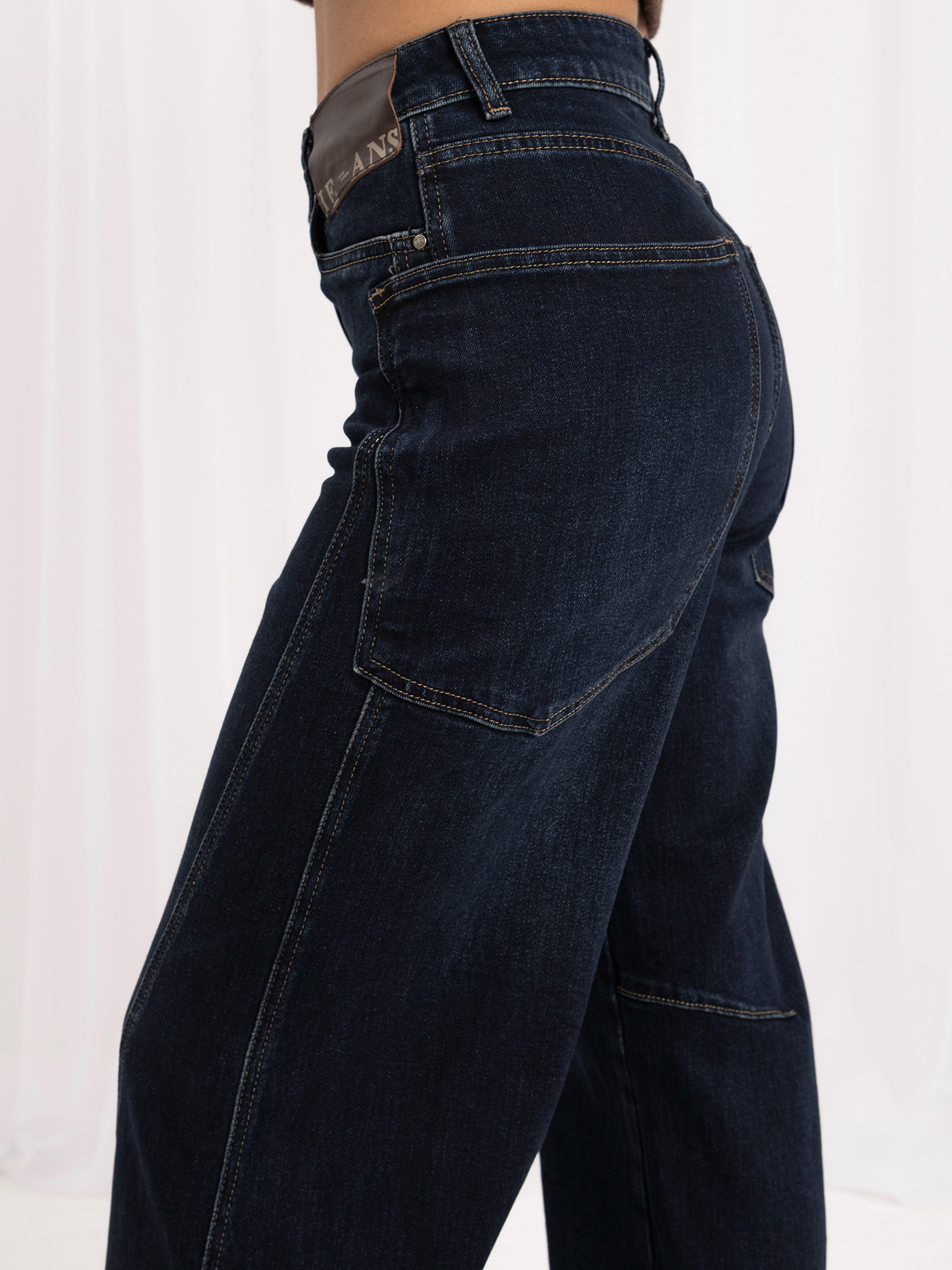 Navy wide leg jeans with geometric stitching.